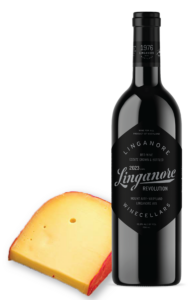 a bottle of Linganore Winecellars Revolution sits next to a gouda cheese wedge