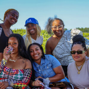 Group of women posing for a photo in front of Linganore Winecellars vineyard