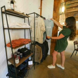 Woman looks at Linganore Winecellars merchandise T-shirt.