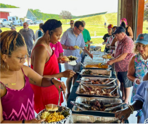 Guests fill their plates at the Linganore Winecellars Wine Club barbeque