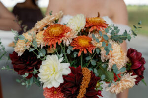 A bride holding a sustainable wedding bouquet.